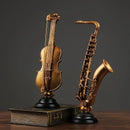 Ornamento Decorativo de Resina Violino e Saxofone Dourado Lenogue